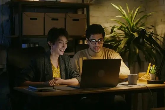 Colegas observando la pantalla de un portátil mientras evalúan los sistemas de IA de su empresa