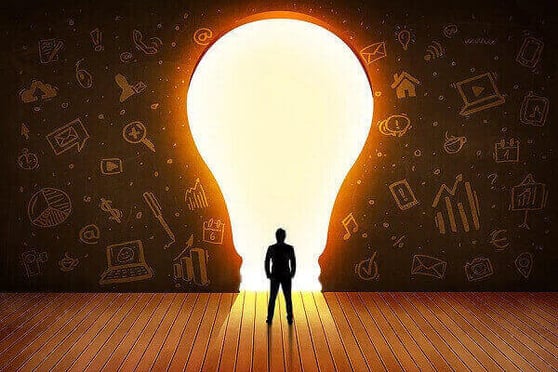 Business man looking at bright light bulb in the wall concept