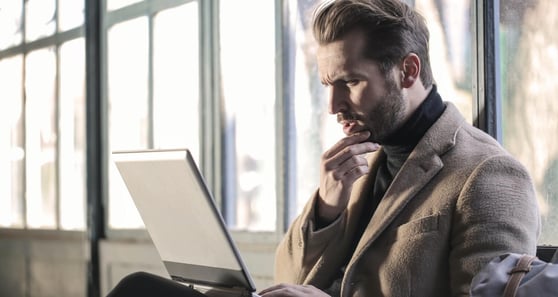 Person reading from a laptop.